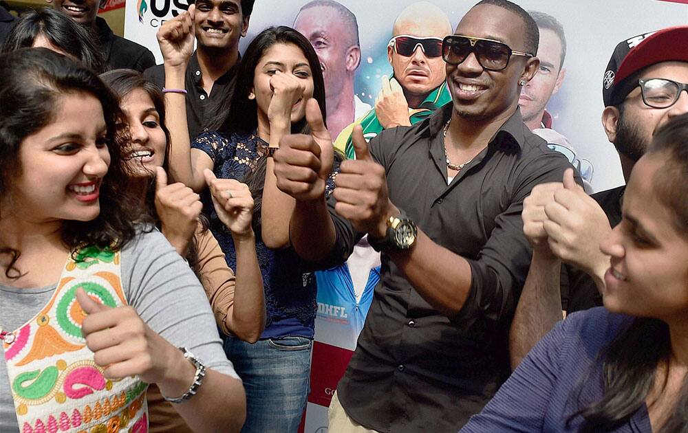 West Indies cricketer Dwayne Bravo dance with fans after launching the Ultimate Sports Coaching Camp at a function in Chennai.