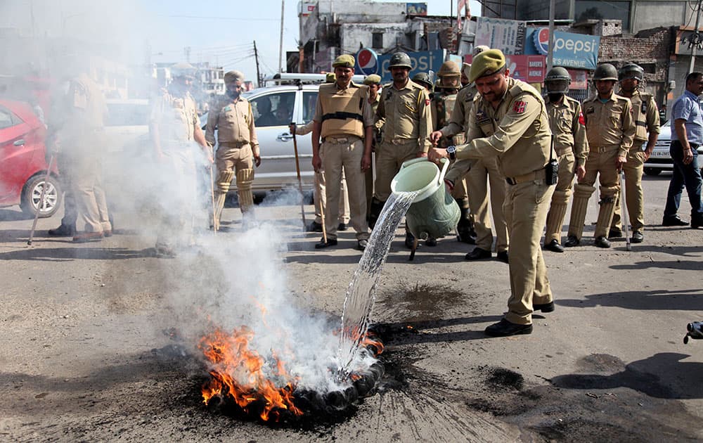 Policemen clear a road block during students protest against police action on students of the National Institute of Technology (NIT) in Srinagar.