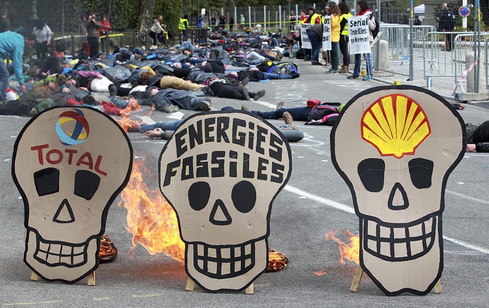 Climate activists stage a die in, outside the summit of a Marine, Construction and Engineering conference in Pau, southwestern France.