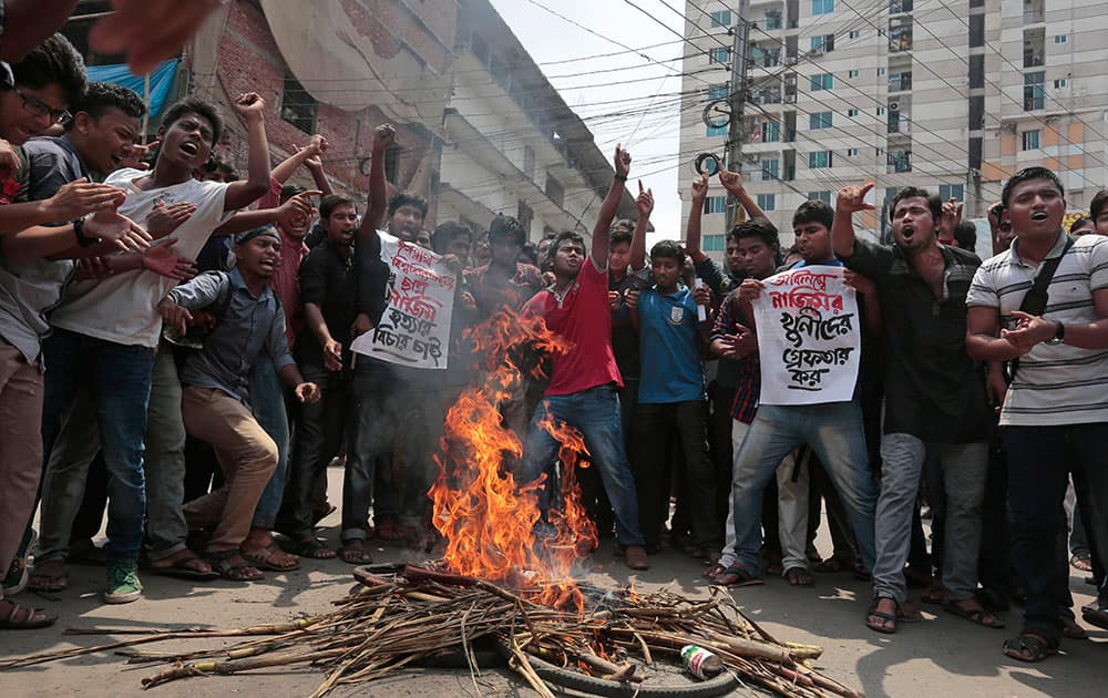 Bangladeshi students protest seeking arrest of three motorcycle-riding assailants who hacked student activist Nazimuddin Samad to death as he walked with a friend, in Dhaka.