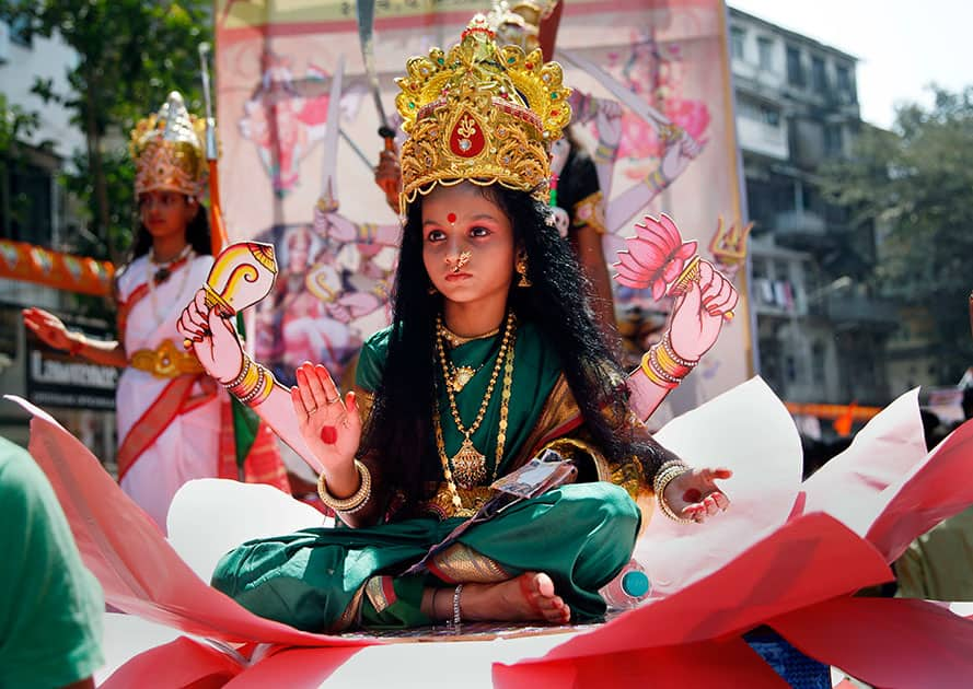 A young Indian girl dressed as Hindu goddess Laxmi participates in a procession to mark 'Gudi Padwa,' or Maharashtrian New Year, in Mumbai.