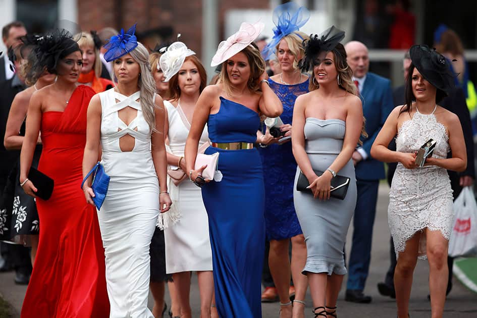 Racegoers promonade as they arrive for the start of Ladies Day of the Grand National Festival at Aintree Racecourse, Liverpool, England.