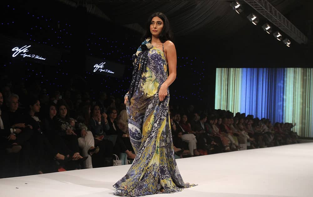 A Pakistani model presents a creation by designer Ayesha F. Haswani during Pakistan Fashion Week in Karachi, Pakistan.