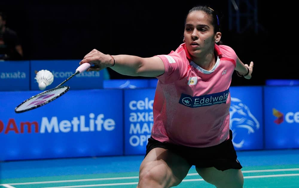 Saina Nehwal of India returns a shot to Tai Tzu Ying of Taiwan during their women's singles semi final match at the Malaysia Open Badminton Superseries in Shah Alam, Malaysia.