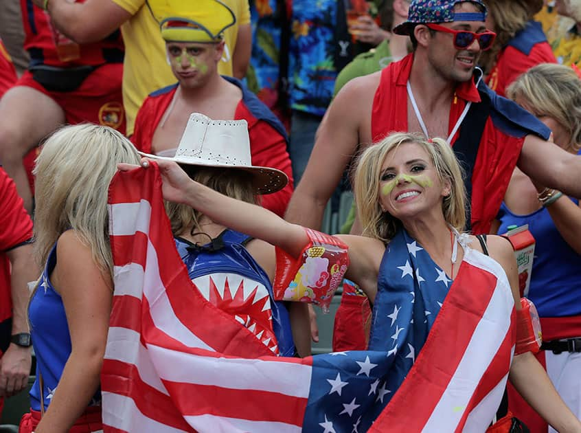 Rugby fans hold a US national flag during a second day of the Hong Kong Sevens rugby tournament in Hong Kong.