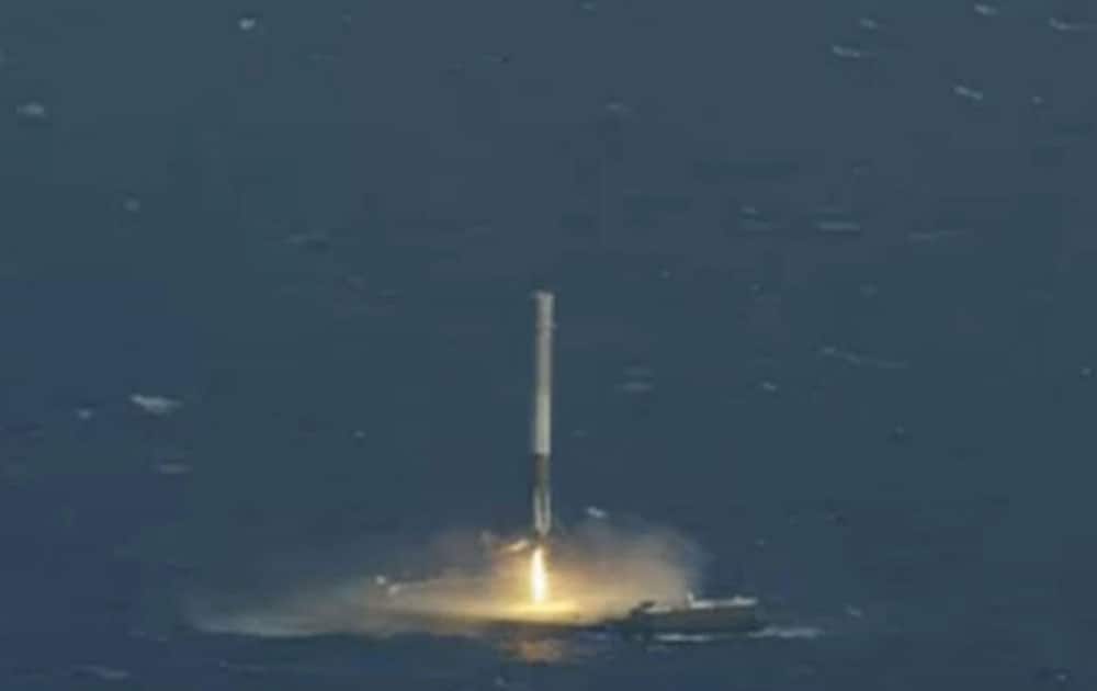 In this image made from video provided by SpaceX, the unmanned Falcon rocket lands on a barge in the Atlantic Ocean.