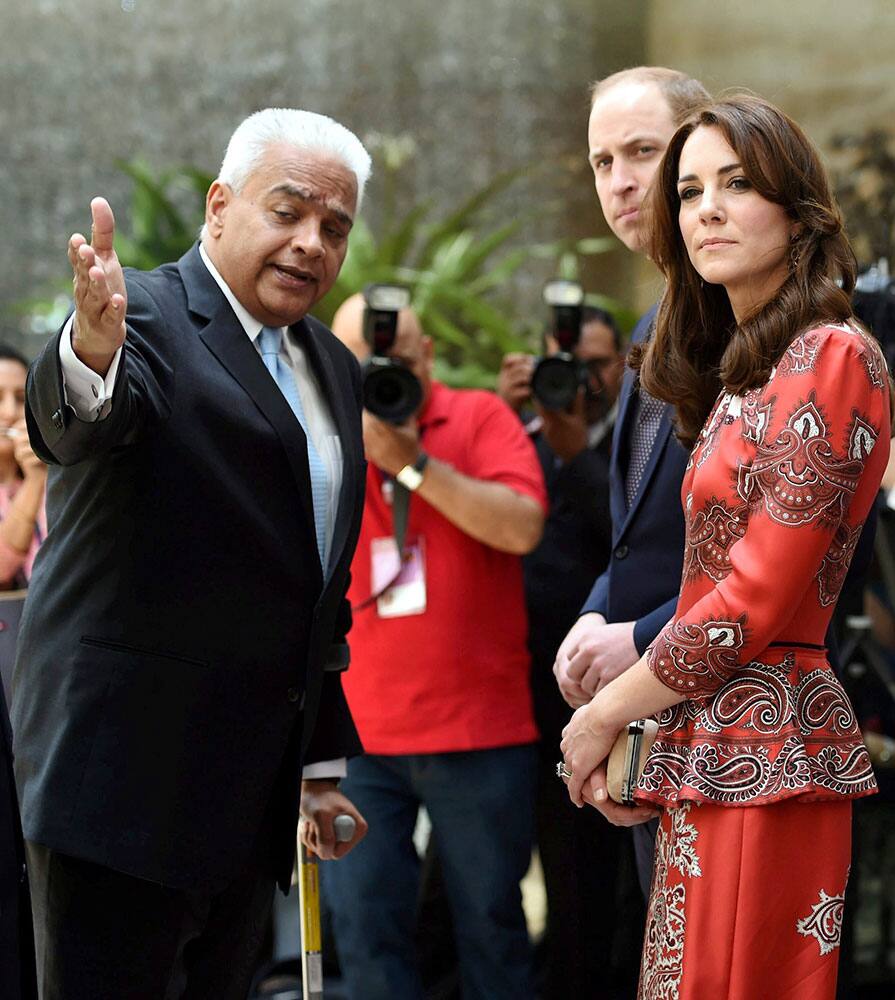 The Duke and Duchess of Cambridge, Prince William, second right and his wife, the former Kate Middleton interact with Rakesh Sarna, MD & CEO of Taj Mahal Palace as they arrive to lay a wreath on the martyrs memorial at the Taj Mahal Palace Hotel in Mumbai, India.