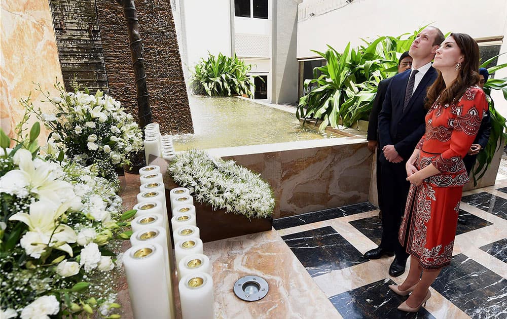 The Duke and Duchess of Cambridge, Prince William, and his wife, the former Kate Middleton stand after laying a wreath on the martyrs memorial at the Taj Mahal Palace Hotel in Mumbai, India.
