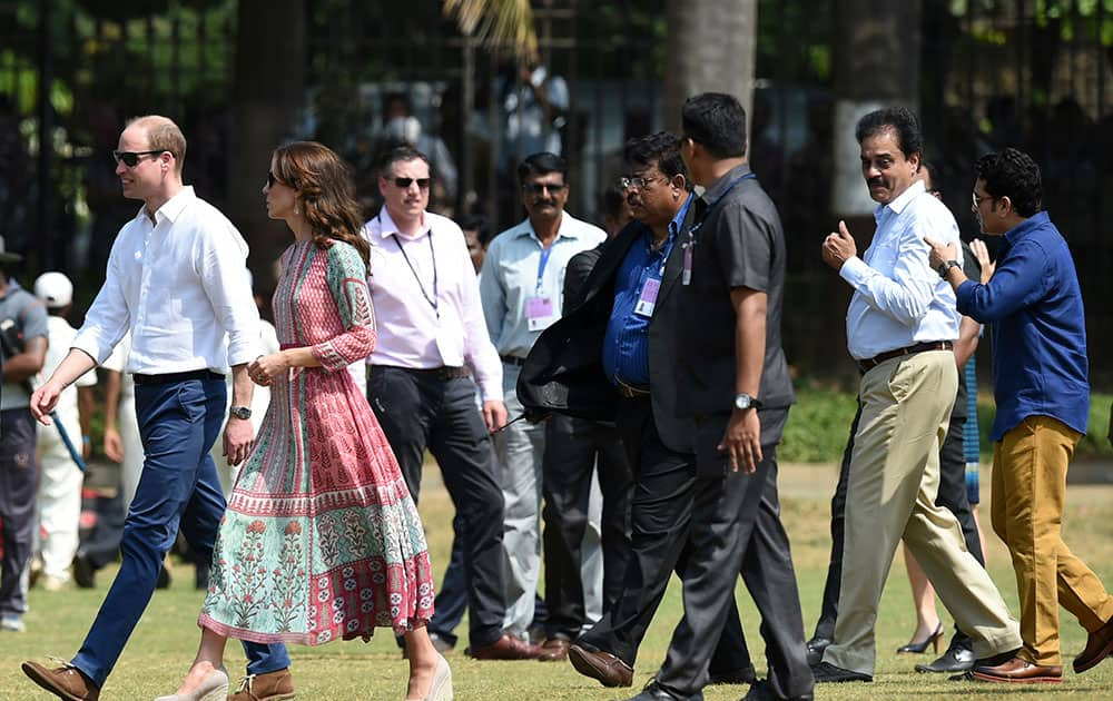 The Duke and Duchess of Cambridge, Prince William, left and his wife, the former Kate Middleton, walk with officials as former Indian cricketers Sachin Tendulkar, right and Dilip Vengsarkar, second right, speak during a charity event at the Oval Maidan in Mumbai, India.