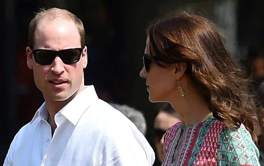 The Duke and Duchess of Cambridge, Prince William, and his wife, the former Kate Middleton, walk with officials during a charity event at the Oval Maidan in Mumbai, India.