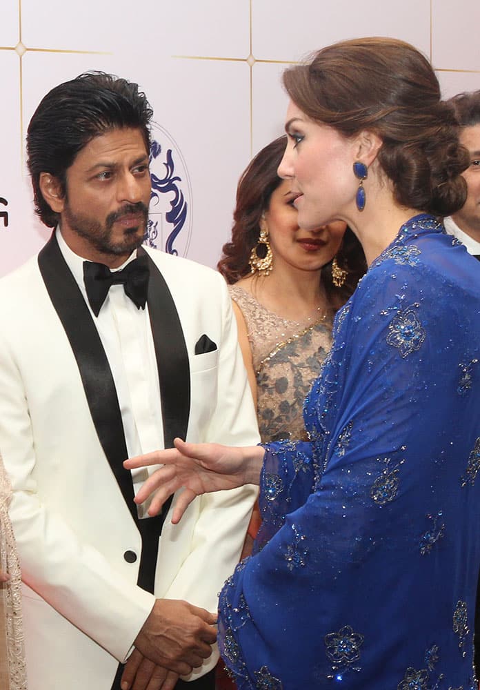 Kate, the Duchess of Cambridge, right, speaks with Bollywood star Shah Rukh Khan, during a charity ball at the Taj Mahal Palace hotel in Mumbai.