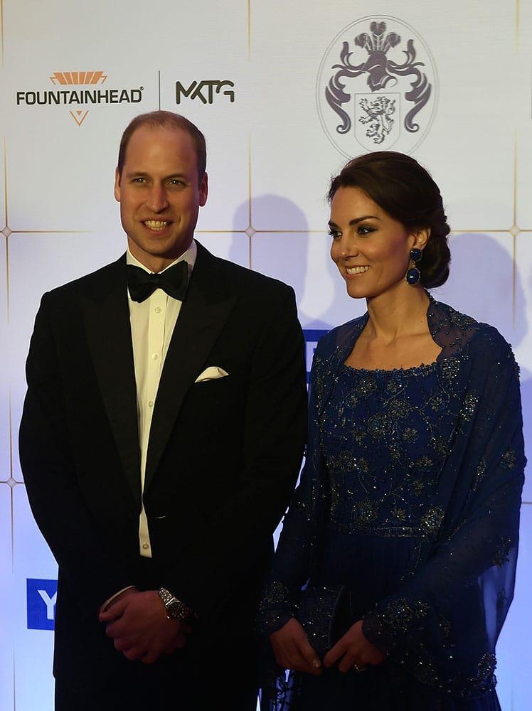 Britain's Prince William, and his wife, Kate, the Duchess of Cambridge, pose after they arrive for a charity ball at the Taj Mahal Palace hotel in Mumbai.