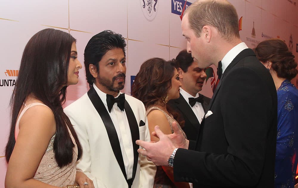 Britain's Prince William, right, speaks with Bollywood stars Shah Rukh Khan and and Aishwarya Rai, left during a charity ball at the Taj Mahal Palace hotel in Mumbai.