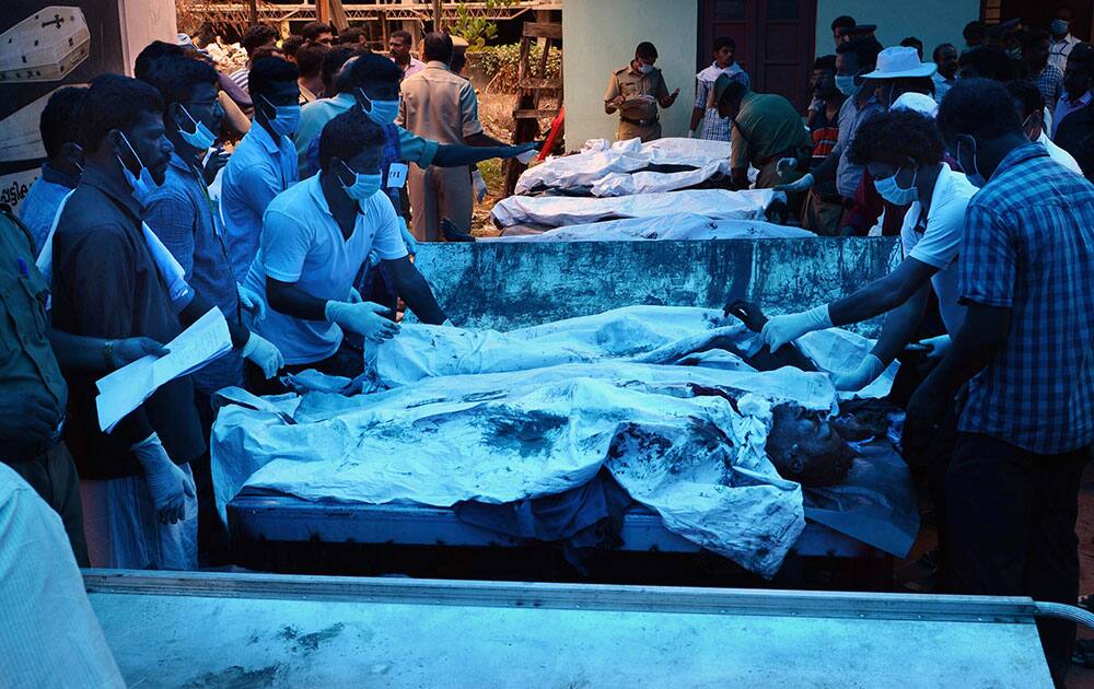 Bodies of victims lie outside a morgue at the Kollam district hospital after a massive fire broke out during a fireworks display at the Puttingal temple complex in Paravoor village, Kollam district, southern Kerala state.