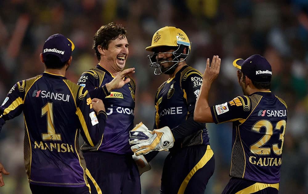 KKR Bowler Brad Hogg jubiliate with his teammates after dismissal of Delhi Daredevils batsman Pawan Negi at Eden Garden in Kolkata.