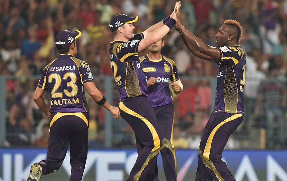 KKR bowler Andre Russell celebrate with team mates after taking wicket during an IPL match against Delhi Daredevils at Eden Garden in Kolkata.