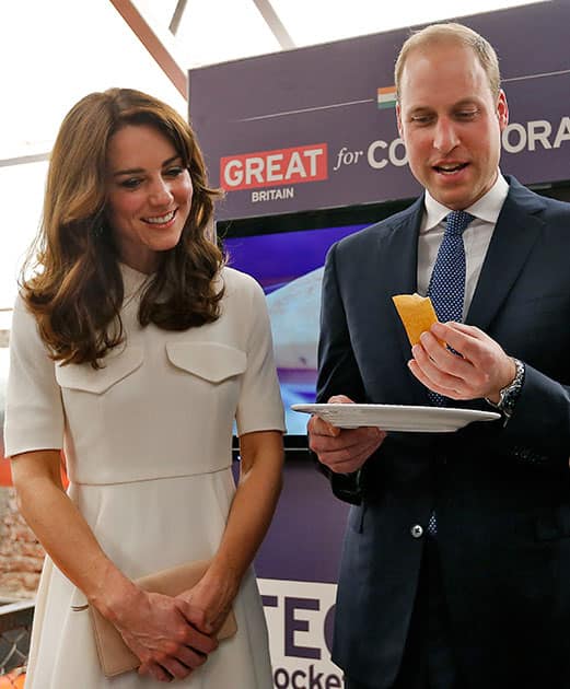 Britain's Prince William eats a 