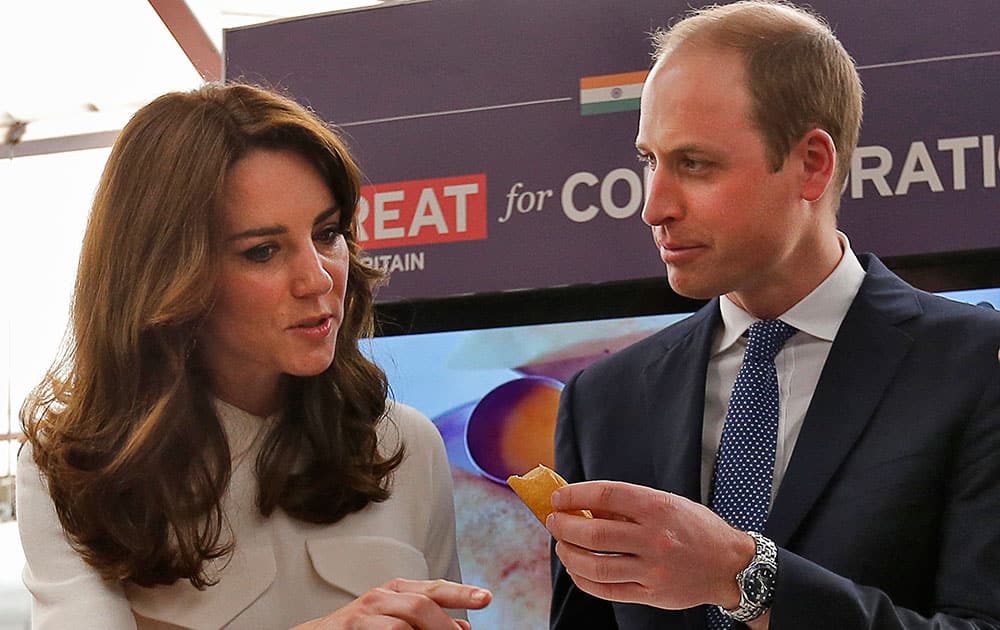 Britain's Prince William eats a 