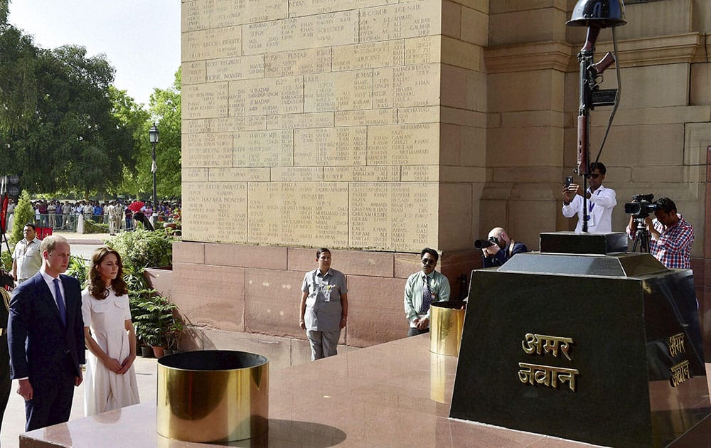 Britains Prince William and his wife, Kate Middleton, the Duchess of Cambridge pay homage at India Gate in New Delhi.