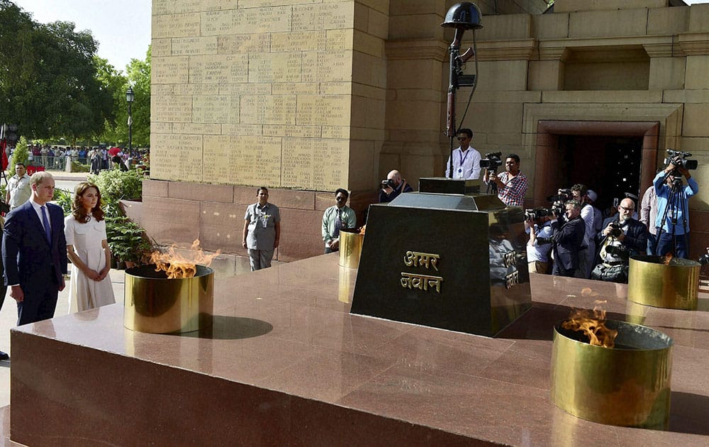 Britains Prince William and his wife, Kate Middleton, the Duchess of Cambridge pay homage at India Gate in New Delhi.