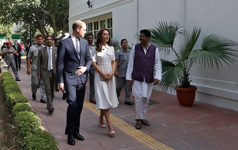Britain's Prince William and his wife Kate, theDuchess of Cambridge, walk during their visit to Gandhi Smriti in New Delhi.
