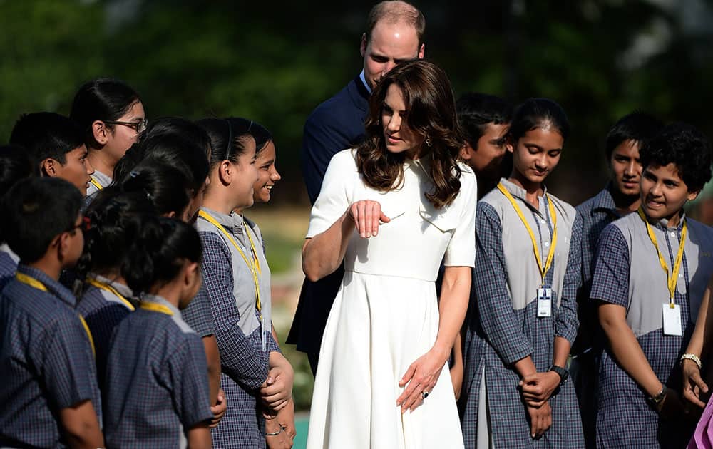 Britain's Prince William, along with his wife Kate, the Duchess of Cambridge interact with school children during a visit to Gandhi Smriti, an Indian museum dedicated to Mahatma Gandhi in New Delhi.