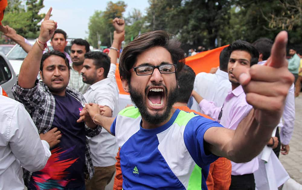 Activists of ABVP protest in front of the vehicle of Director General of Jammu and Kashmir Police over NIT Kashmir issue, in Jammu.