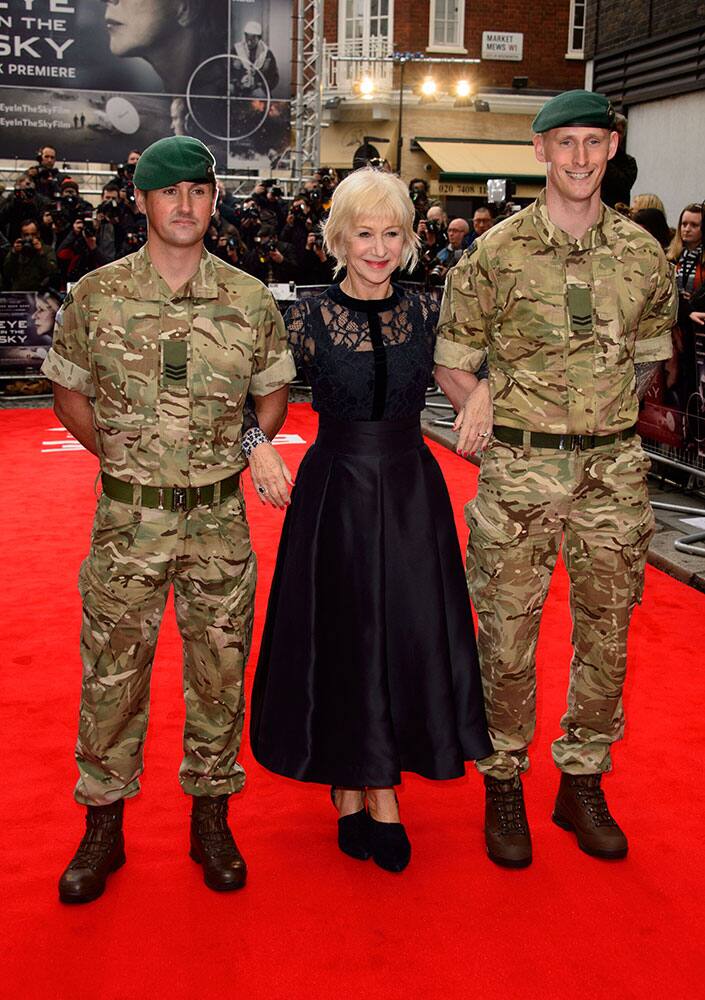 British actress Helen Mirren poses alongside military personel at the UK premiere of the film 'Eye In The Sky' at a central London cinema, London.