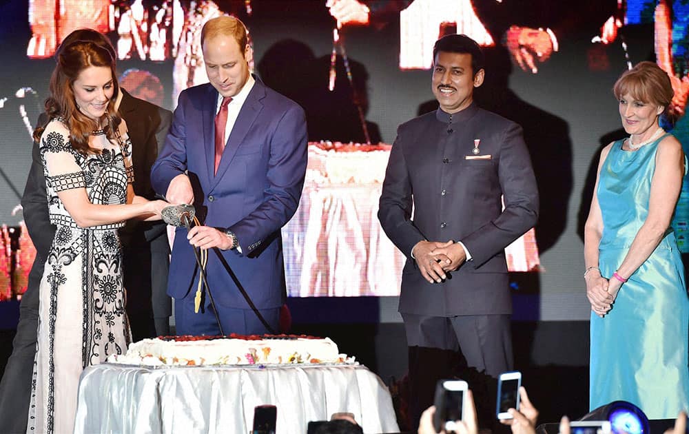 Britain's Prince William, and his wife Kate, the Duchess of Cambridge,cut a cake to celebrate Queen Elizabeth's 90th birthday, which is April 21 at the residence of British High Commissioner in New Delhi.
