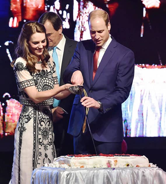 Britain's Prince William, and his wife Kate, the Duchess of Cambridge,cut a cake to celebrate Queen Elizabeth's 90th birthday, which is April 21 at the residence of British High Commissioner in New Delhi.