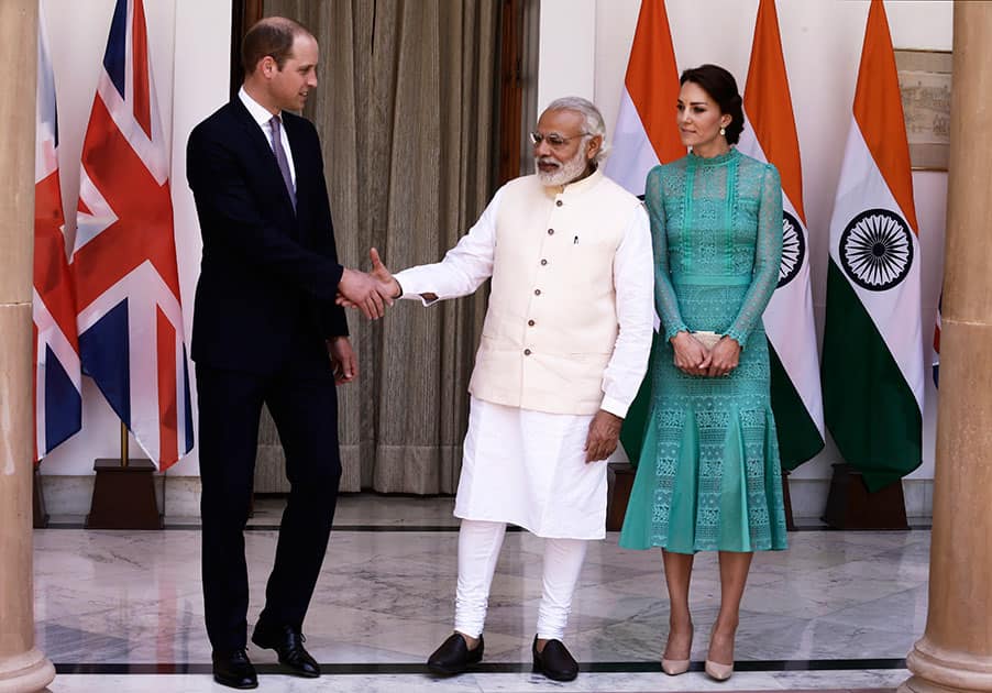 Britain's Prince William and his wife Kate, the Duchess of Cambridge are greeted by Indian Prime Minister Narendra Modi as they arrive for a lunch with him, in New Delhi.