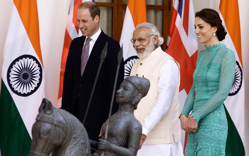 Britain's Prince William and his wife Kate, the Duchess of Cambridge are greeted by Indian Prime Minister Narendra Modi as they arrive for a lunch with him, in New Delhi.