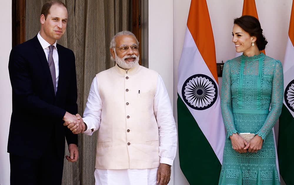 Britain's Prince William and his wife Kate, the Duchess of Cambridge are greeted by Indian Prime Minister Narendra Modi as they arrive for a lunch with him, in New Delhi.