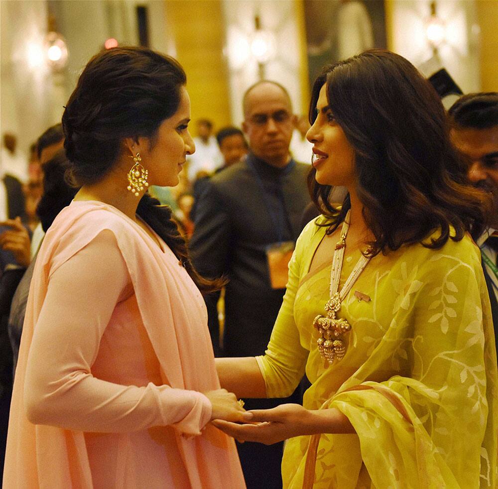 Priyanka Chopra who received Padma Shri award from President Pranab Mukherjee interacts with tennis player Sania Mirza during civil investiture ceremony in New Delhi.