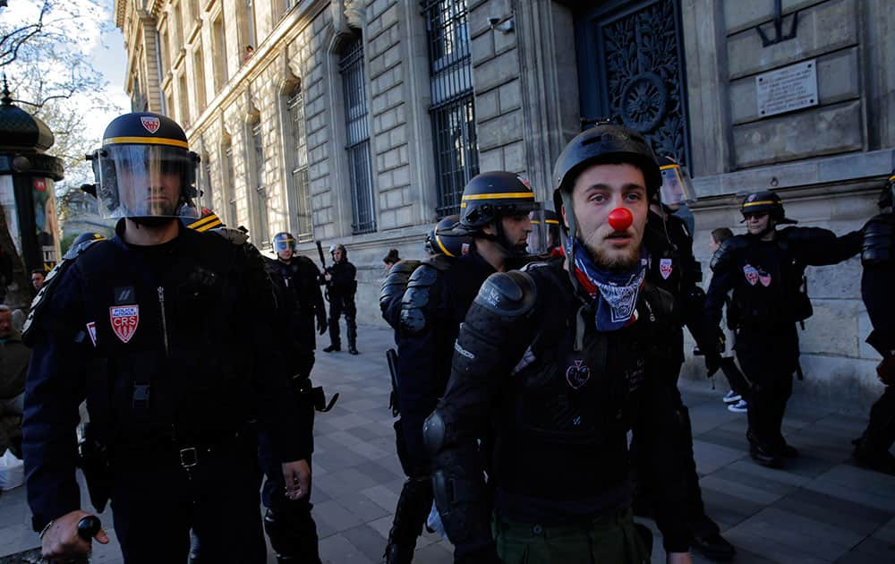 Protestors face riot police as they gather on the Place de la Republique, in Paris.