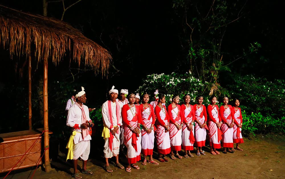 Assamese traditional Jhumur dancers wait to perform before Britain's Prince William, and his wife Kate, the Duchess of Cambridge, in Diphlu River Lodge in the Kaziranga National Park, Assam.
