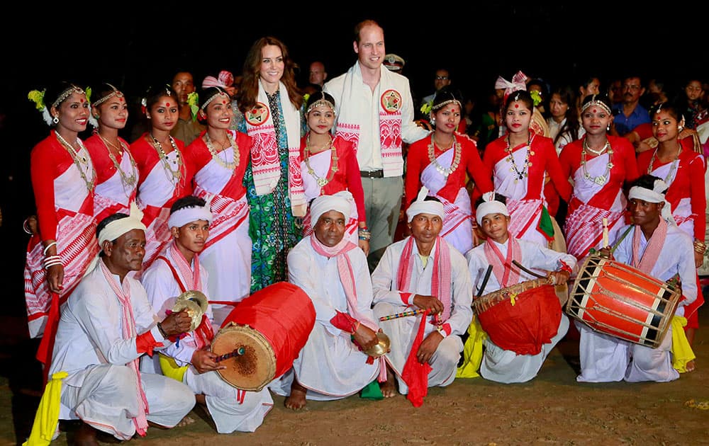 Assamese traditional Jhumur dancers pose with Britain's Prince William, and his wife Kate, the Duchess of Cambridge, in Diphlu River Lodge in the Kaziranga National Park, Assam.