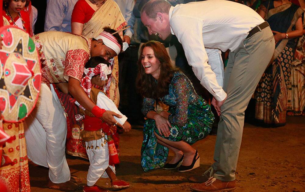 Britain's Prince William along with Kate, the Duchess of Cambridge interact with a very young Assamese traditional Bihu dancer in Diphlu River Lodge in the Kaziranga National Park, east of Gauhati, northeastern Assam