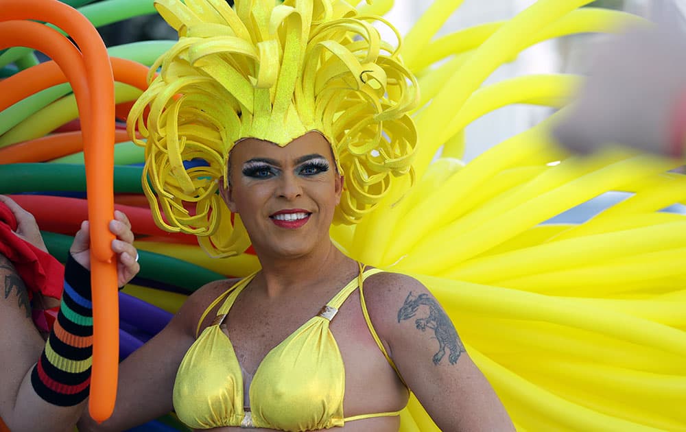 Christian Torrealba wears a costume made of balloons while waiting for the start of a parade along Ocean Drive at Miami Beach Gay Pride, in Miami Beach, Fla. 