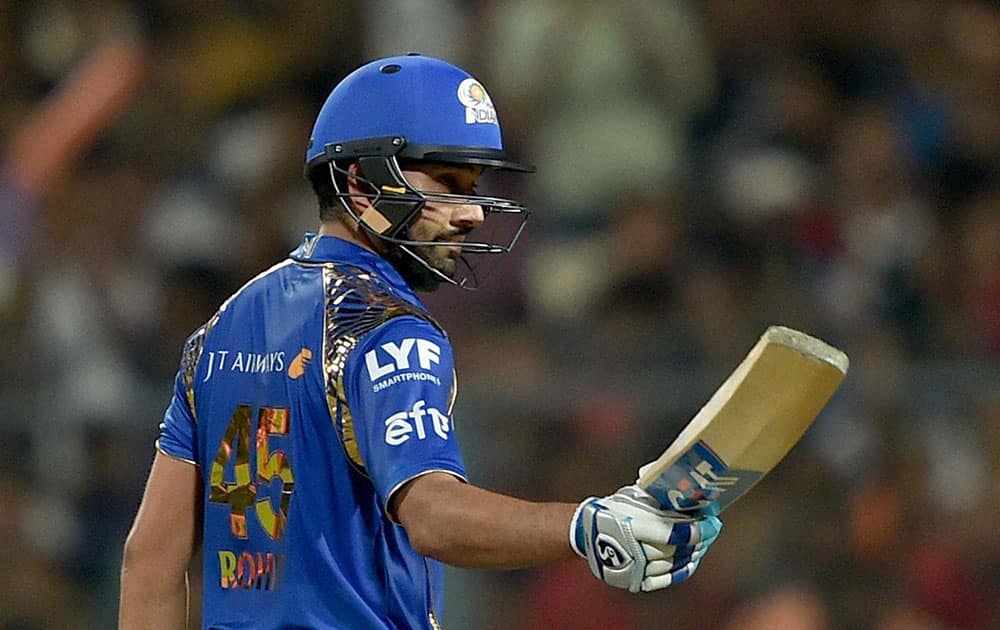 Mumbai Indian batsman Rohit Sharma acknowledges the cheers from the crowd after completing his half century during IPL Match against KKR in Kolkata.
