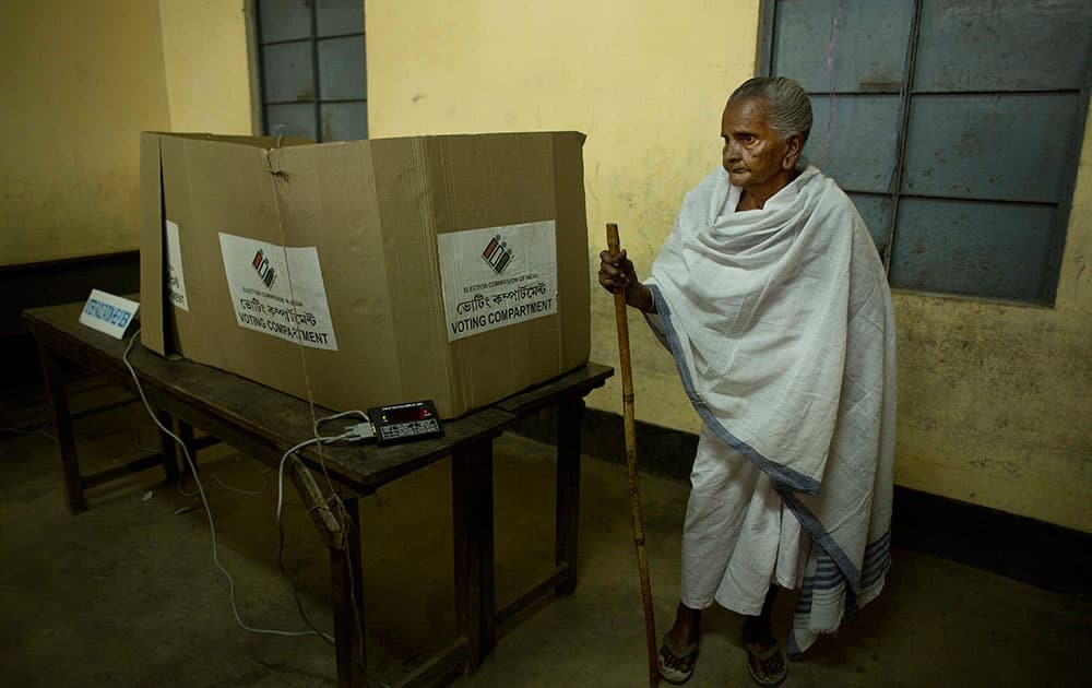 Yashoda Kalita, 102, walks after casting her vote during the second phase of Assam state assembly elections inside a polling station on the outskirts of Guwahati, Assam.