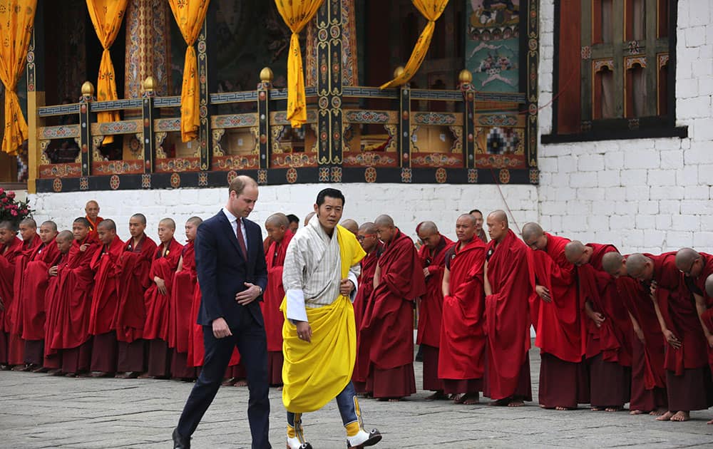 This photo provided by Royal Kingdom of Bhutan, Britain's Prince William left, walks with Bhutan's king, Jigme Khesar Namgyel Wangchuk, in Thimphu, Bhutan.