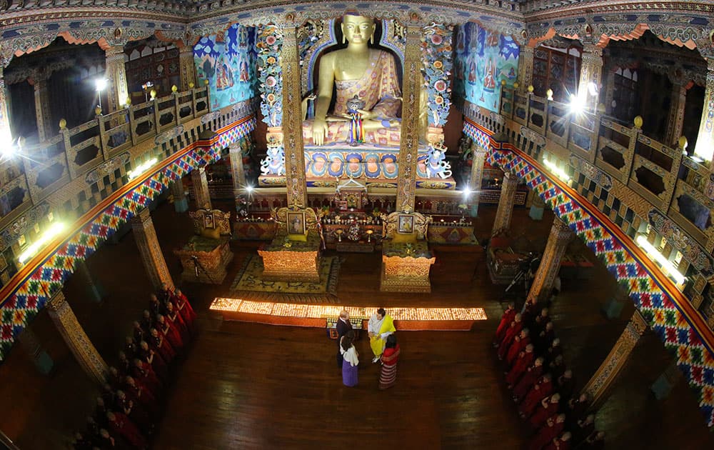 Royal Kingdom of Bhutan, Bhutan's king Jigme Khesar Namgyel Wangchuk, in yellow, Bhutan's queen, Jetsun Pema, in red, Britain's Prince William, left top, and Kate, Duchess of Cambridge are seen inside a Buddhist temple in Thimphu, Bhutan.