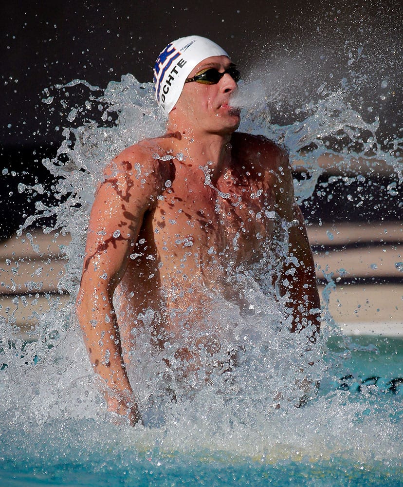 Ryan Lochte warms up in the practice pool prior to competing in the 200-meter backstroke final during the Arena Pro Swim Series swim meet.