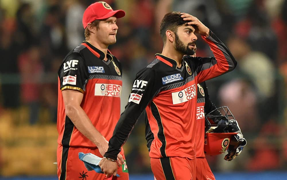 Royal Challengers Bangalore Skipper Virat Kohli and Shane Watson returns the pavilion after they lost against Delhi Daredevils during Indian Premier League (IPL) 2016 T20 match in Bengaluru.