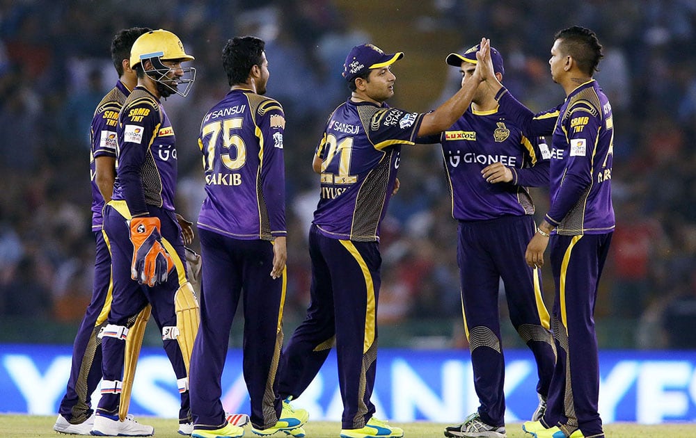 Piyush Chawla of Kolkata Knight Riders and Sunil Narine of Kolkata Knight Riders celebrate getting Glenn Maxwell of Kings XI Punjab wicket during the Indian Premier League (IPL) 2016 T20 match , in Mohali.