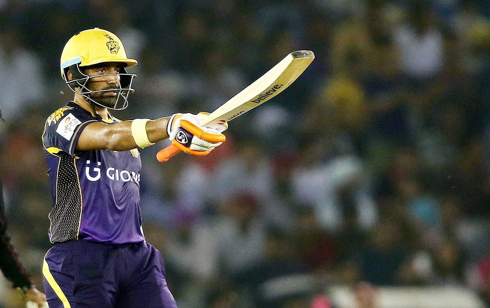 Kolkata Knight Riders batsman Robin Uthappa raises his bat after reaching his fifty against Kings XI Punjab during the Indian Premier League (IPL) 2016 T20 match , in Mohali.