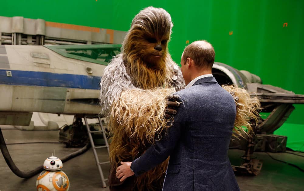 Britain's Prince William talks with the Star Wars character Chewbacca during a tour of the Star Wars sets at Pinewood studios in Iver Heath, west of London.