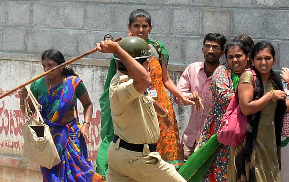 Police charge the garment workers who were protesting over EPF withdrawal norm, in Bengaluru.
