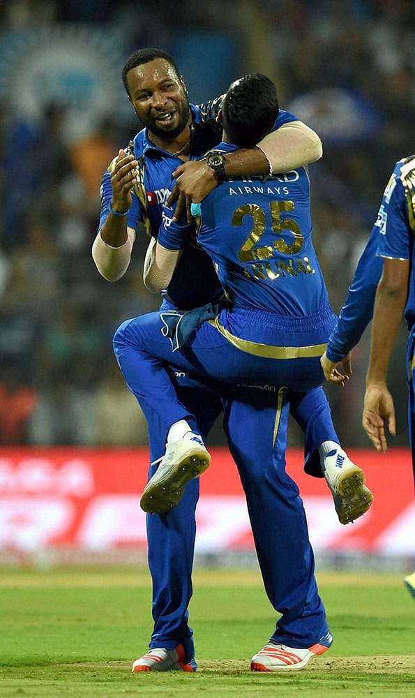 Mumbai Indians player Krunal Pandya celebrate with K Pollard after taking the wicket of AB de Villiers during the IPL match against Royal Challengers Bangalore.